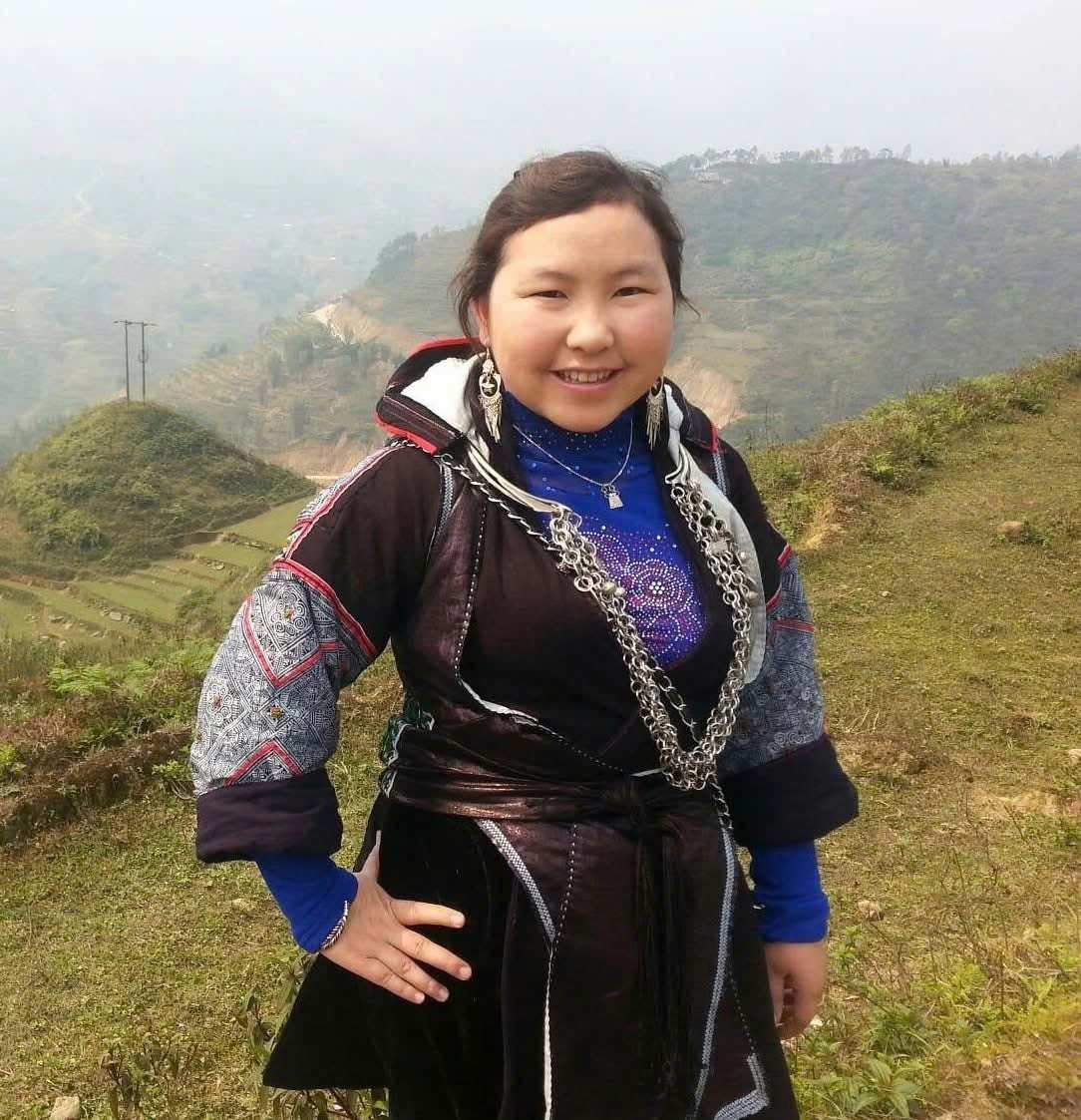 Guest trying on a heirloom Hmong costume for photos